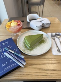 a plate with a piece of cake and a book on it